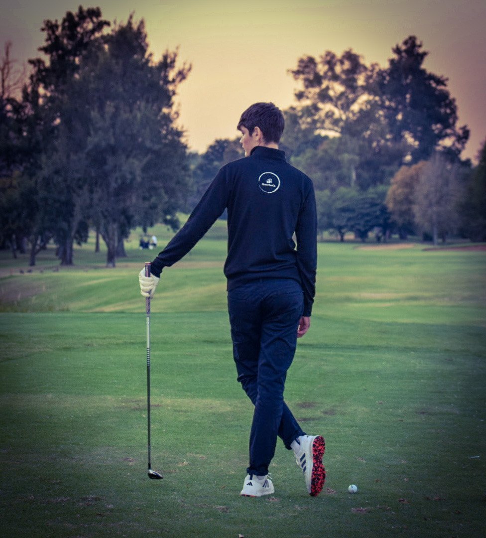 Golfer wearing Green Tee Co apparel on a fairway